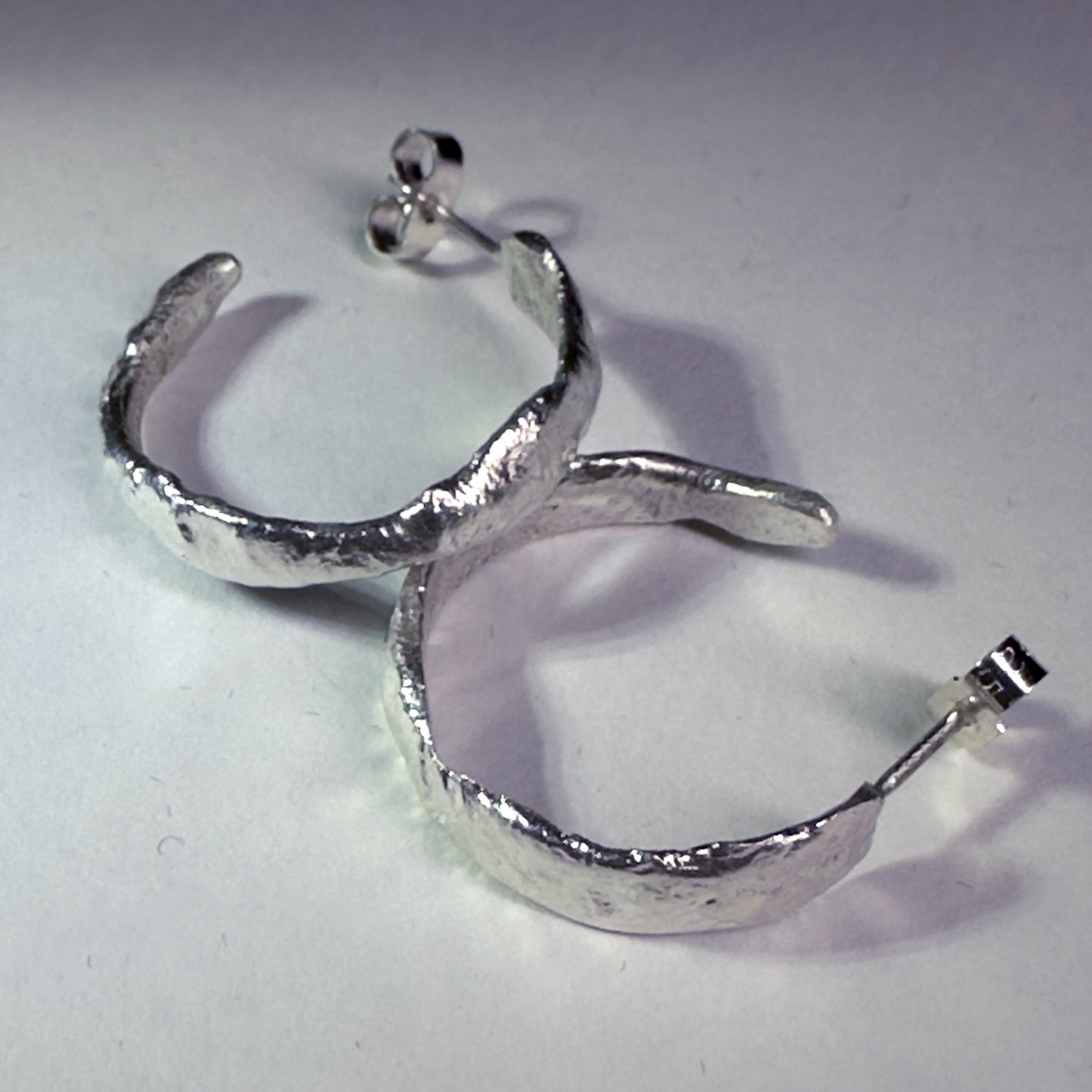 Silver reticulated hoops with white background