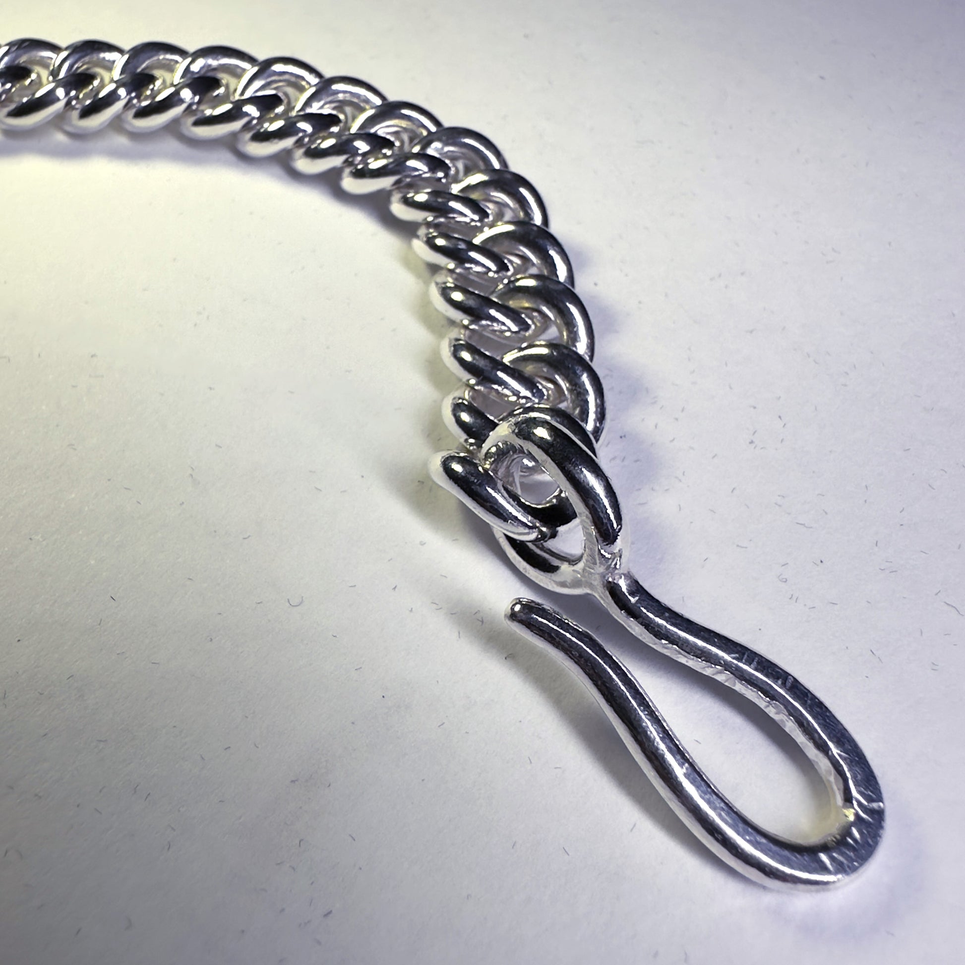 Heavy duty curb chain bracelet on white background